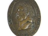 an image of a bronze coin with a woman on it