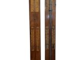 pair of antique wooden wall mounted thermometers with brass accents
