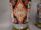 two vases that have been decorated with orange and blue designs