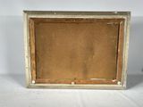 an old picture frame sitting on top of a white table