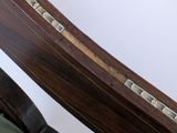 a close up of a wooden chair with a green seat