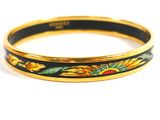 a close up of a yellow and black bracelet with sunflowers on it