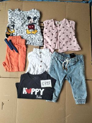 a lot of clothes that are laying out on a cardboard box
