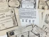 several old french bank notes are scattered together on a white surface