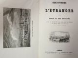 an open book with a picture of a city on it