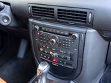 a car dashboard with a steering control and a dash button