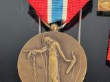 a medal with a woman holding a sword and a cross on it