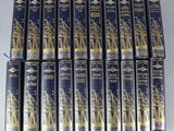 un lot de six livres ornés de dorures, posés sur une table