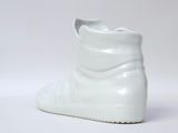 a close up of a pair of white shoes on a white surface