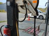 a hose attached to a pole with a fire extinguisher nearby