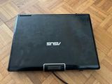 an open laptop computer sitting on top of a hard wood floor