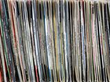 an image of a stack of vinyl records sitting on top of a table