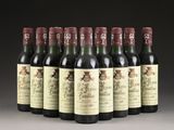 six bottles of wine lined up in a row on a table