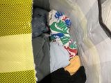 a baby in a crib with a stuffed animal inside of it