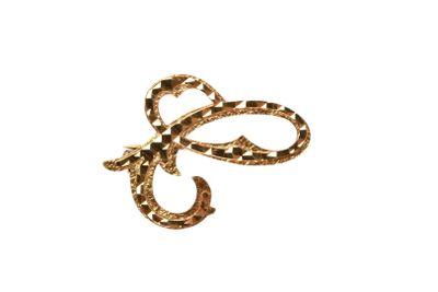 an image of a gold bow brooch on a white background