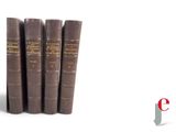 several books are lined up in a row on a white surface
