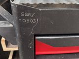 a black and red drawer with a red drawer underneath it