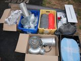 a box of assorted items sitting on the ground next to a box of other items