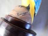 a close up of a wooden object with a bird on it