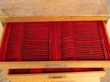a wooden box with a red cloth inside of it