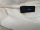 a close up of a white shirt with a black label on it