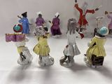 many figurines of people dressed in different costumes