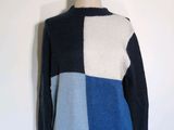 the sweater is blue, white, and black with a patchwork design