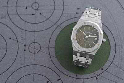 a watch sitting on top of a table on a table