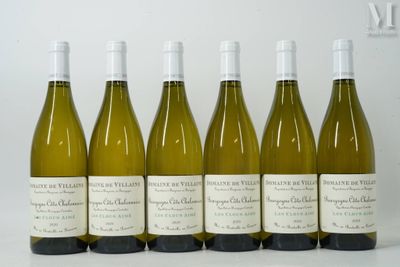 six bottles of white wine lined up in a row on a table