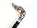 a close up of a walking stick on a white surface