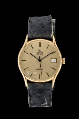 une image d'une montre-bracelet en or avec un bracelet en cuir noir