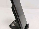 a close up of a cell phone on a stand on a table