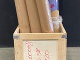 a wooden crate with several rolls of wrapping on top of it