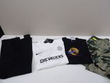 several t - shirts and pants are lined up on a table