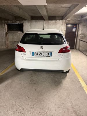 a small white car parked in a parking garage