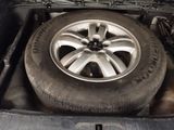 a tire in the back of a truck with a flat tire