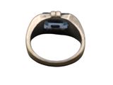 a silver ring with a blue stone in it