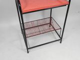 a black and red shelf with a red tray on top of it
