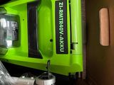 a box with a green and black vacuum in it