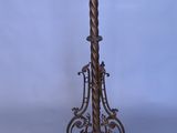 an antique brass floor lamp with a glass shade on top