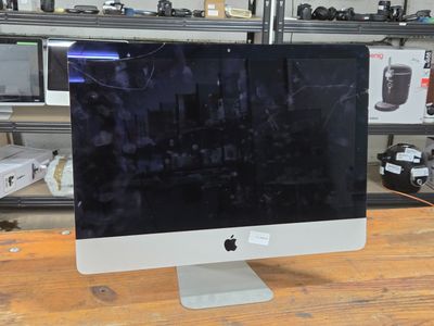 a computer monitor sitting on top of a wooden table