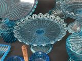 many blue glass dishes and bowls on the table