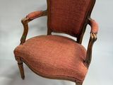 an old chair with a red upholstered upholstered upholstered seat