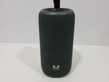 an image of a black speaker sitting on top of a white table