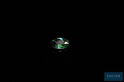 un gros plan d'un diamant vert sur fond noir