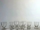several empty wine glasses are lined up on a white surface