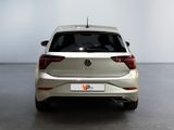the rear end of a silver volkswagen v - cross parked in a white room