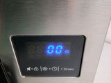 a digital clock on the side of a microwave