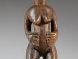 an image of a wooden statue of a woman holding a baby