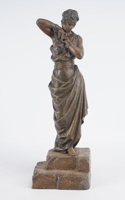bronze statue of a woman holding a bird on a stone base